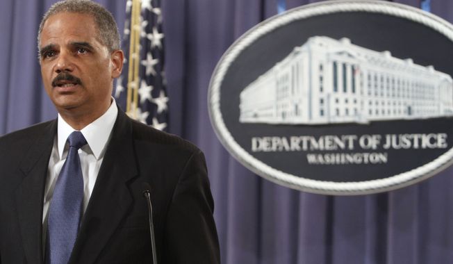 TURNABOUT: Attorney General Eric H. Holder Jr. blamed hindrances by members of Congress. (Associated Press)