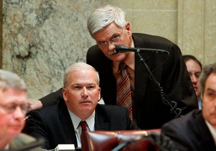 Wisconsin state Sen. Mark Miller (standing) talks to Senate Majority Leader Scott Fitzgerald, a Republican, during a session at the Capitol in Madison, Wis., on Tuesday. (Associated Press)