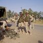 First Lieutenant Ungaro and Second Lieutenant Tilly standby as EOD preps a robot at an IED site in Iraq. (U.S. Army)