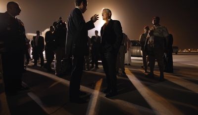 Defense Secretary Robert M. Gates (center) talks with his press secretary, Geoff Morrell, on the airport apron before departing from Riyadh, Saudi Arabia, on Wednesday, April 6, 2011. Mr. Gates earlier met with King Abdullah. (AP Photo/Chip Somodevilla, Pool)