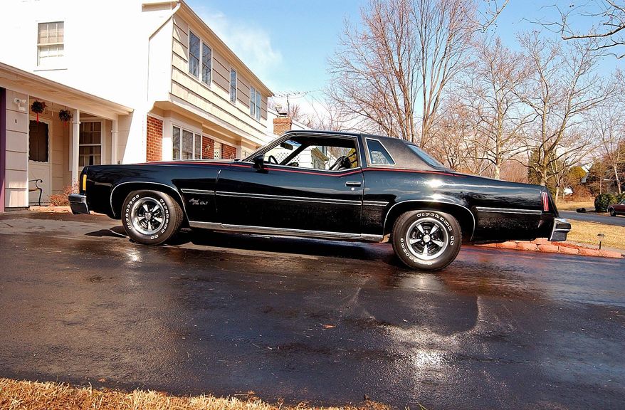 The long engine hood helps identify the 1977 Pontiac Grand Prix SJ riding on Rally II wheels.