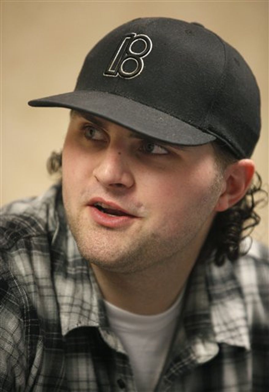 In this Monday, April 4, 2010, photo New York Jets quarterback Erik Ainge ices his foot during a physical therapy session at the Pro Sports Therapy clinic, in Waltham, Mass. Ainge has been on a tumultuous journey _ marked by years of drug and alcohol abuse. It's taken him from high school star in Oregon to big man on campus at the University of Tennessee and all the way to the NFL. Now he's a recovering drug addict with bipolar disorder and a surgically repaired foot, trying to rebuild his once-shattered life under the roof of his famous uncle Danny. (AP Photo/Steven Senne)