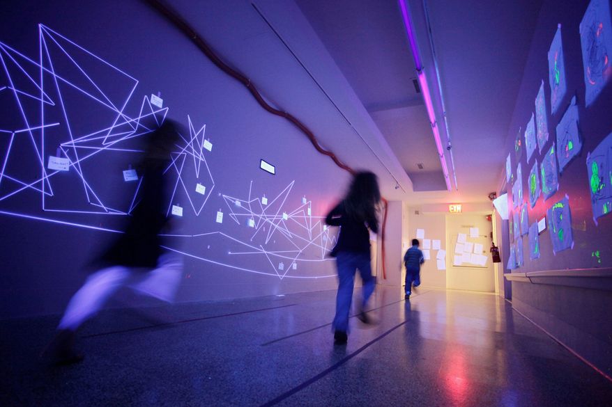 Black light illuminates a hallway at the Blue School in New York. The private school was founded by members of the Blue Man Group so they could have a school creative enough for their own children. (Associated Press)