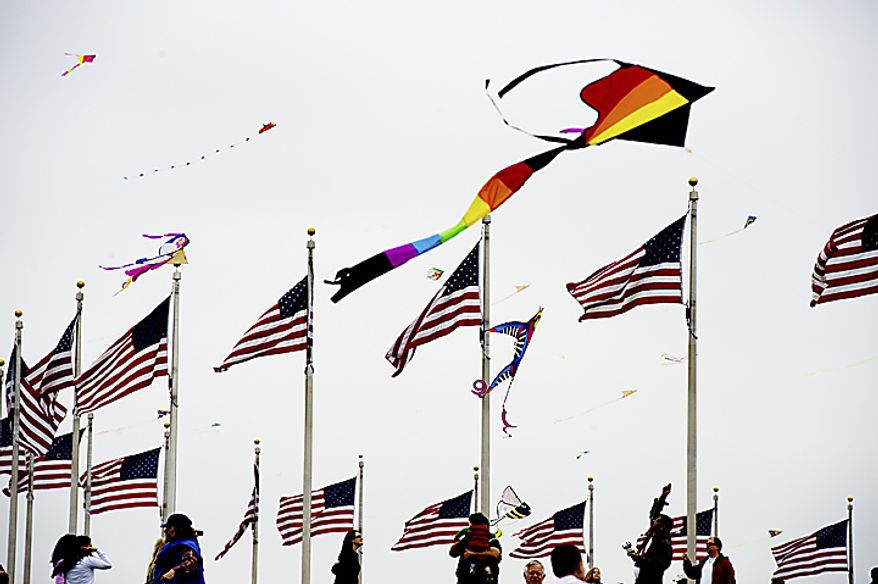 Kites fly near the base of the Washington Monument during the annual kite festival on the National Mall, in Washington, Sunday, April 10, 2011. After 44 years of Smithsonian sponsorship, this was the first year the kite festival was put on by the National Cherry Blossom Festival. (Drew Angerer/The Washington Times)