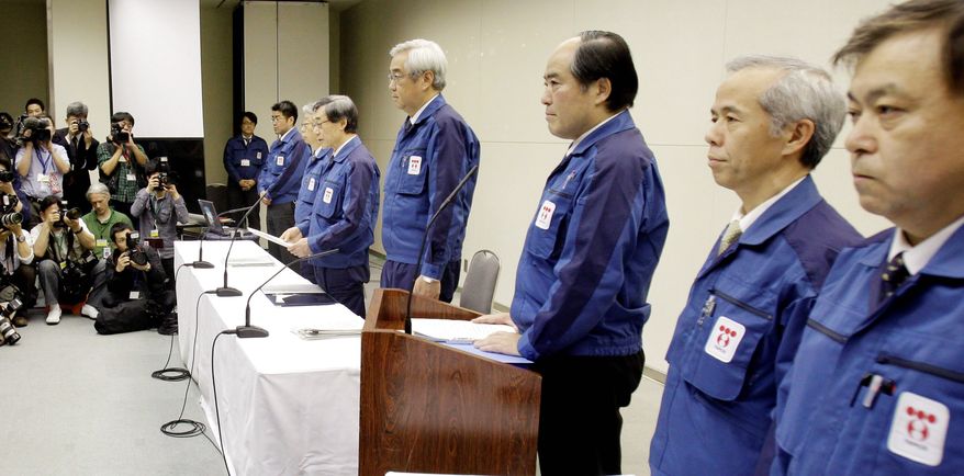 "I offer my apologies for having spread radiation. I apologize from the bottom of my heart," said Tokyo Electric Power Co. President Masataka Shimizu (fifth from right) as he and other Tepco executives took questions for two hours Wednesday at Tepco headquarters in Tokyo. (Associated Press)