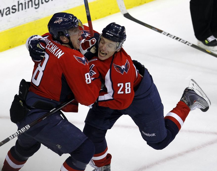 Washington Capitals&#39; Alexander Semin (28) and Alex Ovechkin (8), both from Russia, celebrate Ovechkin&#39;s goal in the third period of Game 1 of a first-round NHL hockey playoff series with the New York Rangers, Wednesday, April 13, 2011, in Washington.(AP Photo/Alex Brandon)