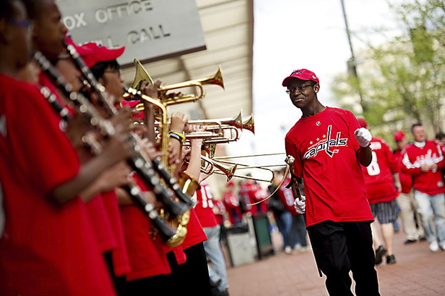 Freedom High School drum major Caleb Wesley from Woodbridge, Va., pumps up his pep band as they perform before a Capitals playoff game against the New York Rangers in Washington on Wednesday, April 13, 2011. (Drew Angerer/The Washington Times)
