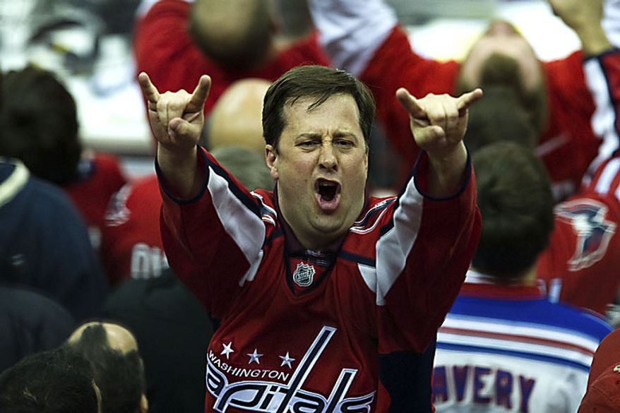 A Capitals fan celebrates after Alex Ovechkin tied the game at 1-1 during the third period of a playoff match against the New York Rangers at the Verizon Center in Washington on Wednesday, April 13, 2011. (Drew Angerer/The Washington Times)