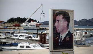 A poster depicting Gen. Ante Gotovina is seen in harbor in his hometown of Pakostane, southern Croatia, Thursday, April 14, 2011. (AP Photo/Darko Bandic)