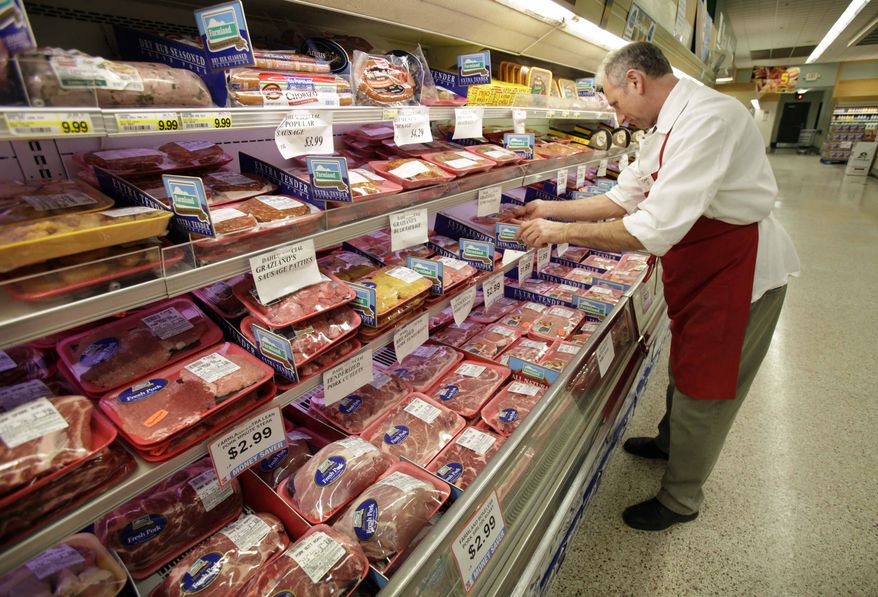 Meat department manager Kevin Morlan arranges packages of pork at a Dahl's grocery store in Des Moines, Iowa, on March 3, 2011. (AP Photo/Charlie Neibergall)