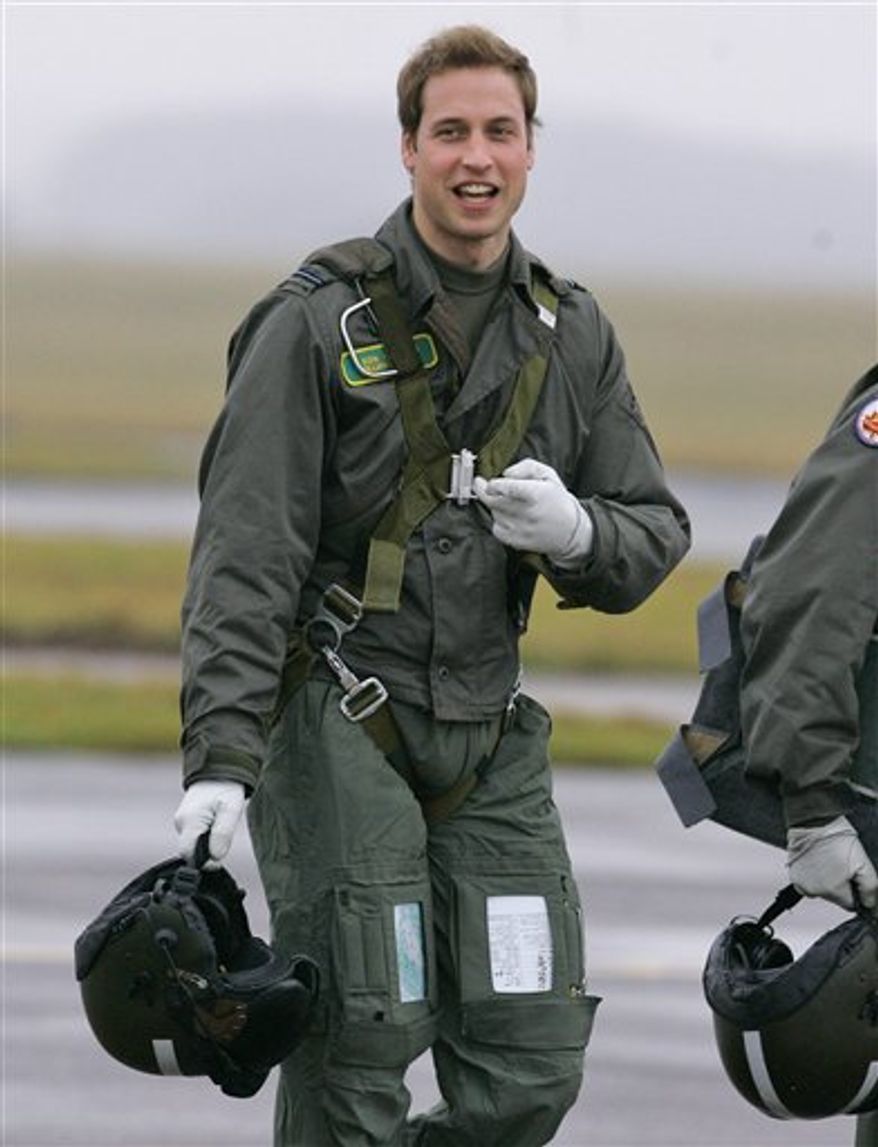 FILE - In this Thursday, Jan. 17, 2008, file photo Britain's Prince William gestures as he walks across the airfield at RAF Cranwell, Lincolnshire, England. Britain's monarchy has an enduring connection to the armed forces Prince William is part of the fourth successive generation to have served as a pilot. His grandmother, Queen Elizabeth II, is the military's ceremonial chief and joined the Women's Auxiliary Territorial Service during World War II, reaching the rank of junior commander and training as a driver. (AP Photo/Kirsty Wigglesworth/file)