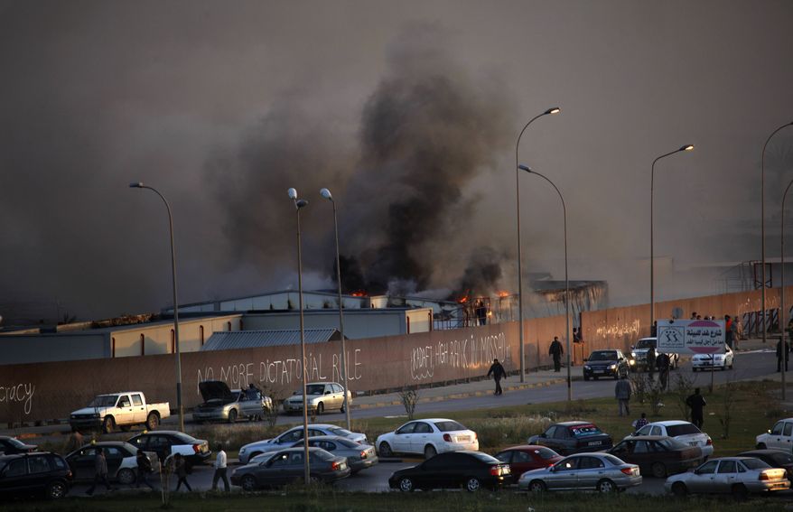 Fire and smoke rises from storage warehouse at a construction site that is run by a foreign company, with no clear causes of the incident, in Benghazi, Libya Friday, April 15, 2011. (AP Photo/Nasser Nasser)