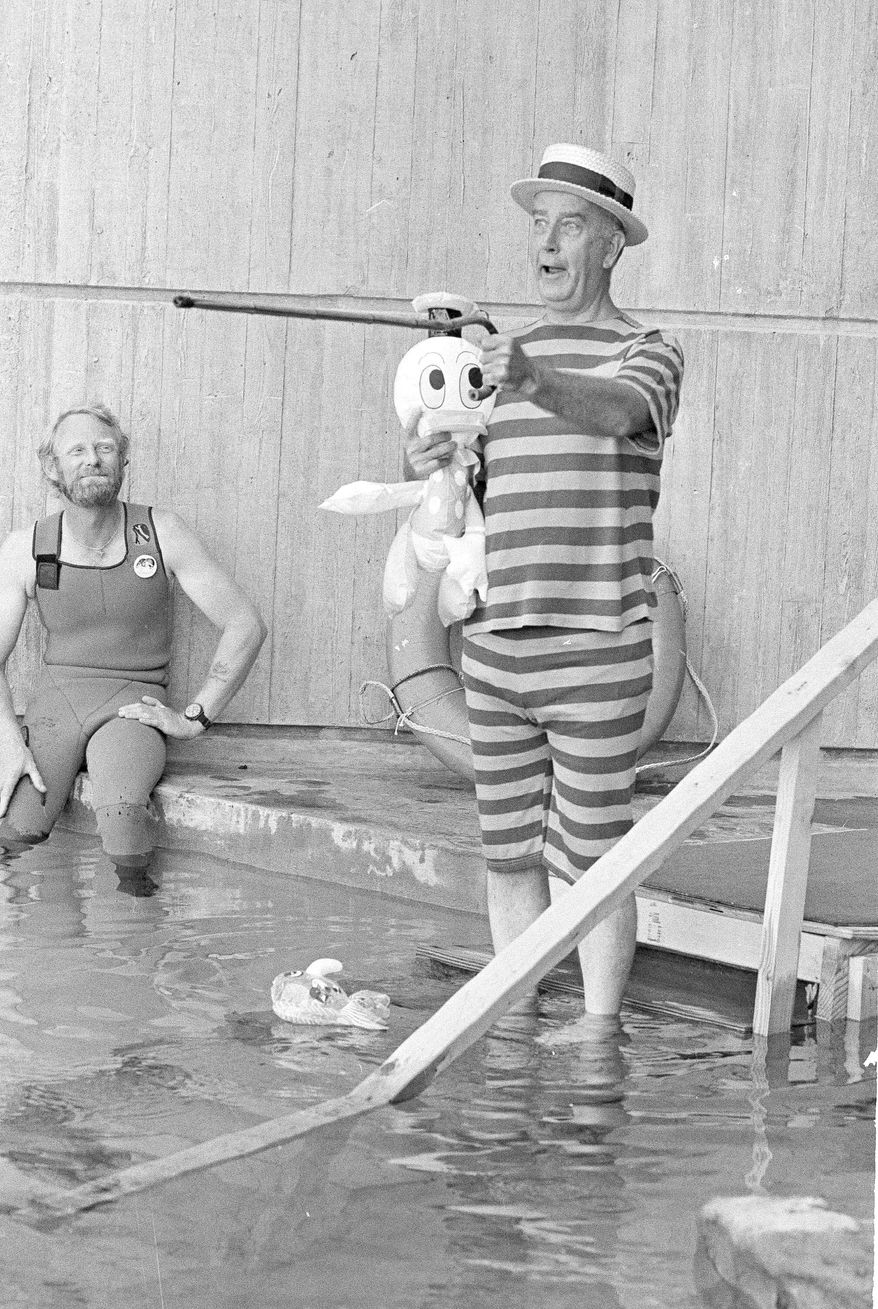 ASSOCIATED PRESS PHOTOGRAPHS
On Sept. 9, 1981, then-Baltimore Mayor William Donald Schaefer, dressed to amuse, enters one of the tanks of the National Aquarium in Baltimore to settle a bet. He is credited with rejuvenating the Inner Harbor.