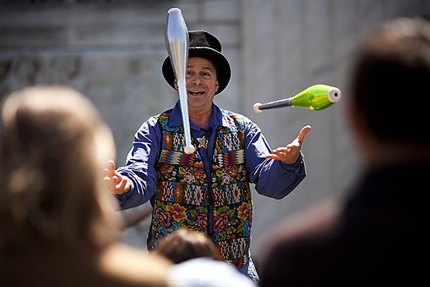 Renaissance era jester and entertainer Nick Newlin juggles for the crowd during an open house for Shakespeare's Birthday at the Folger Shakespeare Library, in Washington, D.C., Sunday, April 17, 2011. (Drew Angerer/The Washington Times)