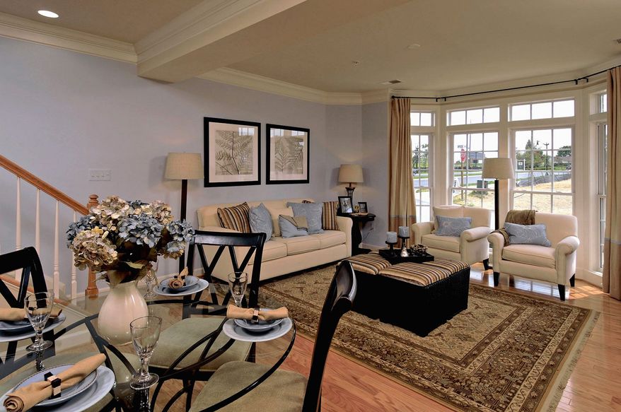The Picasso model, an upper-level home in the stacked town-home-style condominium community at the Villages of Urbana, has a living room and dining room at the front of the main level.