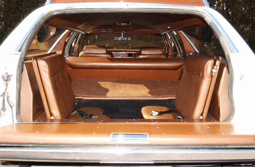 Dual-facing rear seats have seat belts plus cargo space.