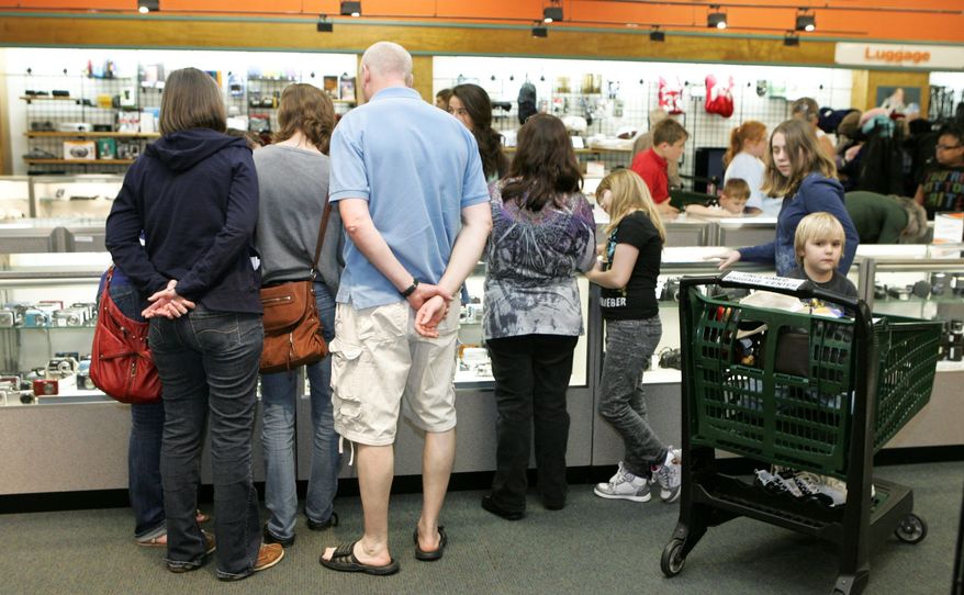 Customers peruse cameras and other electronics at the 40,000-square-foot store, which offers merchandise ranging from shoes to samurai swords at between 20 percent and 80 percent off. (Associated Press)