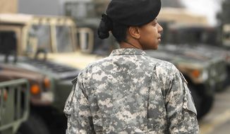 ** FILE ** Army Maj. Sequana Robinson models a woman&#39;s combat uniform on Saturday, March 31, 2011, at Fort Belvoir, Va. (Associated Press)