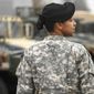 ** FILE ** Army Maj. Sequana Robinson models a woman&#39;s combat uniform on Saturday, March 31, 2011, at Fort Belvoir, Va. (Associated Press)