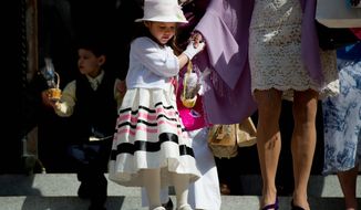 Wearing her Sunday best, 5-year-old Mercedes Webster walks down the church steps after Easter Mass at the historic Cathedral of St. Matthew the Apostle on Rhode Island Avenue in the District. The service, attended by an overflow congregation, focused largely on Scripture. (Drew Angerer/The Washington Times)