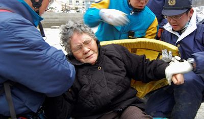 Sumi Abe, 80, is rescued from her tsunami-destroyed home in Ishinomaki, Japan, on March 20. Likely the most famous of the tsunami survivors, Mrs. Abe has come to personify the enduring spirit that many believe will help Japan overcome its worst crisis since World War II. (Asahi Shimbun via Associated Press)