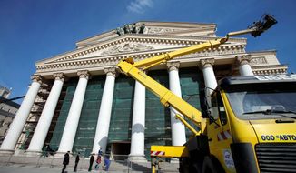 A construction crane is utilized outside the Bolshoi Theater in Moscow. The construction company says 3,500 workers are still busy adding sophisticated electronic and hydraulic devices, redesigning the stage floor to ease the ballet dancers&#39; pain and completing an underground stage located just a short distance from a metro station. (Associated Press)