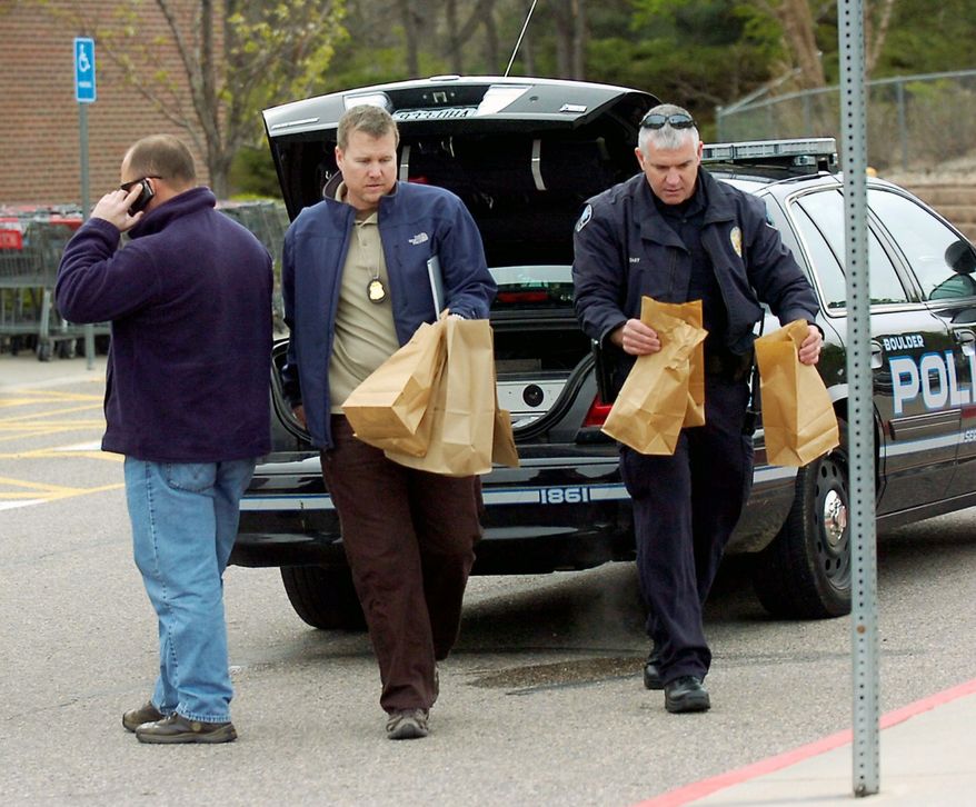 ASSOCIATED PRESS PHOTOGRAPHS
Investigators collect evidence at King Soopers grocery store morning in Boulder, Colo., where a suspect in a case involving an undetonated pipe bomb and two propane tanks at a Denver-area shopping mall on April 20 was arrested.