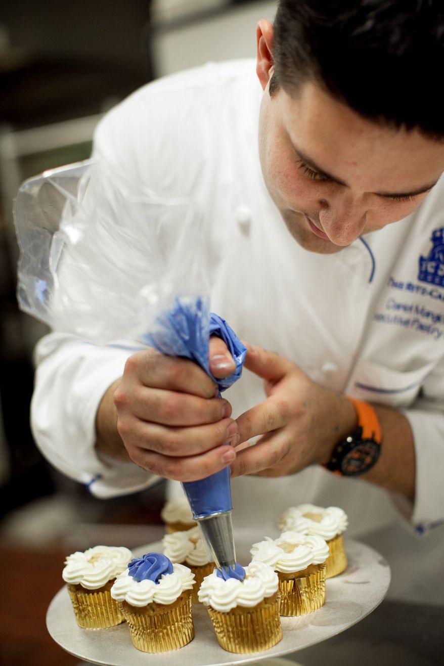 ** FILE ** Daniel Mangione, a chef at the Ritz-Carlton in Georgetown, prepares cupcakes. (NICHOLAS GINGOLD/SPECIAL TO THE WASHINGTON TIMES)