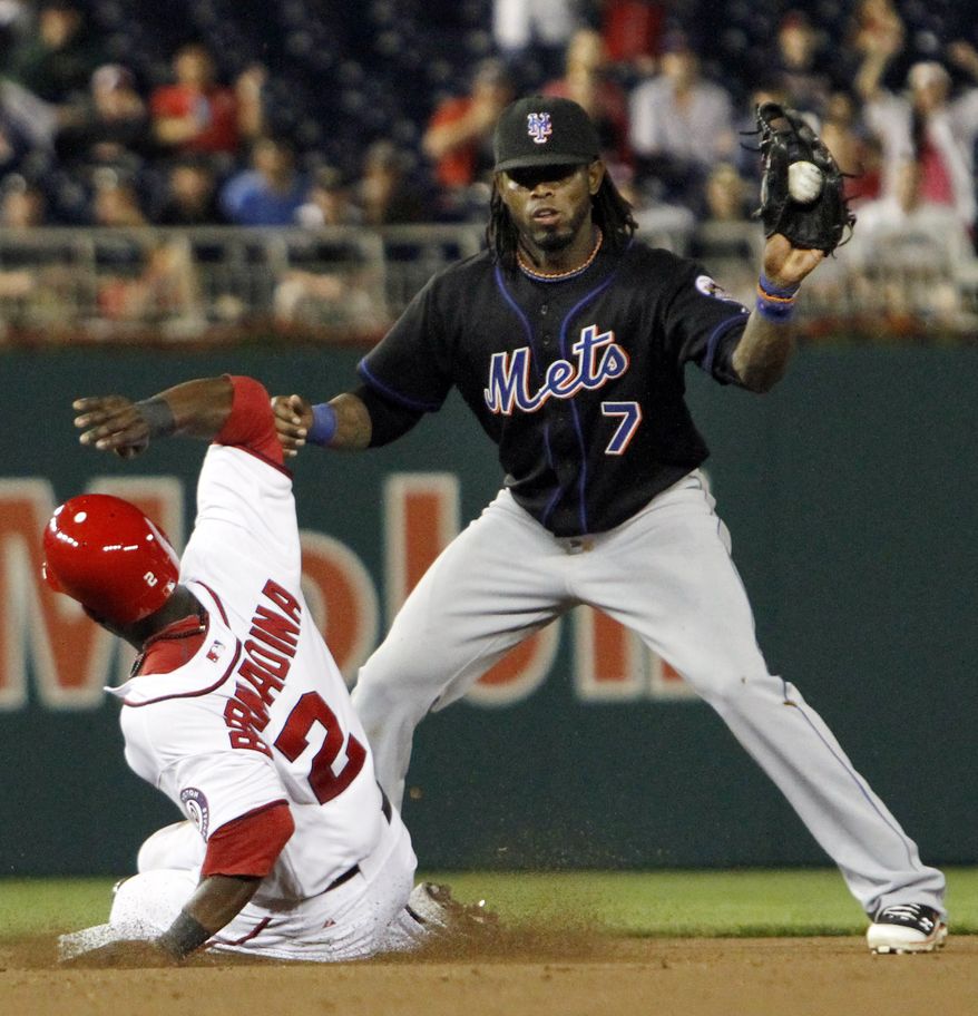 Washington Nationals' Roger Bernadina (2) slides safely onto second base as New York Mets shortstop Jose Reyes (7) catches the ball during the seventh inning of a baseball game at Nationals Park, in Washington, on Wednesday, April 27, 2011. Bernadina advaned from first on a throwing error by Mets pitcher R.A. Dickey. The Mets won 6-3. (AP Photo/Jacquelyn Martin)