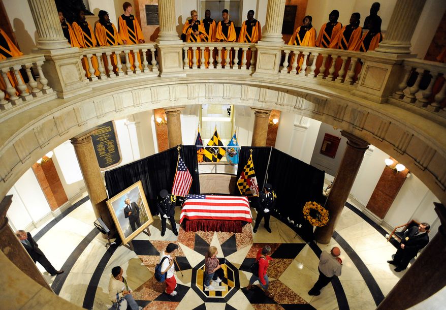 Members of the public pay their respects to William Donald Schaefer, former Baltimore mayor and former Maryland governor and comptroller, at City Hall in Baltimore on Tuesday, April 26, 2011, as the Baltimore City College High School "Singing, Swingin' Knights" choir performs on the balcony. (AP Photo/Steve Ruark, Pool)