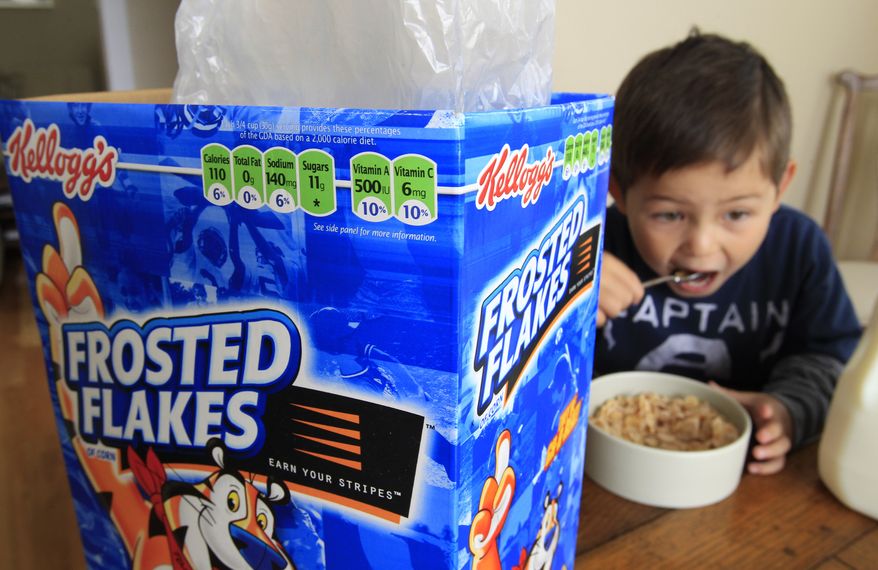 Nathaniel Donaker, 4, eats Kellogg's Frosted Flakes cereal at his home in Palo Alto, Calif., on Thursday. Commercials promoting sugary breakfast cereals could be put on a strict diet under government guidelines urging food companies to limit marketing of unhealthy products to children. Under a proposal announced Thursday by several government agencies, companies would be urged to only market foods to children ages 2 through 17 if they are low in fats, sugars and sodium and contain specified healthy ingredients. (Associated Press)