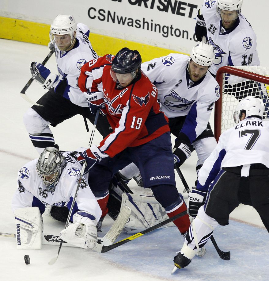 Tampa Bay Lightning goalie Dwayne Roloson (35), with Eric Brewer (2), Brett Clark (7), Dominic Moore (19), Sean Bergenheim (10) from Finland, work against Washington Capitals center Nicklas Backstrom from Sweden, during the second period in Game 1 of a conference semifinal NHL Stanley Cup hockey playoff series Friday, April 29, 2011 in Washington.(AP Photo/Alex Brandon)
