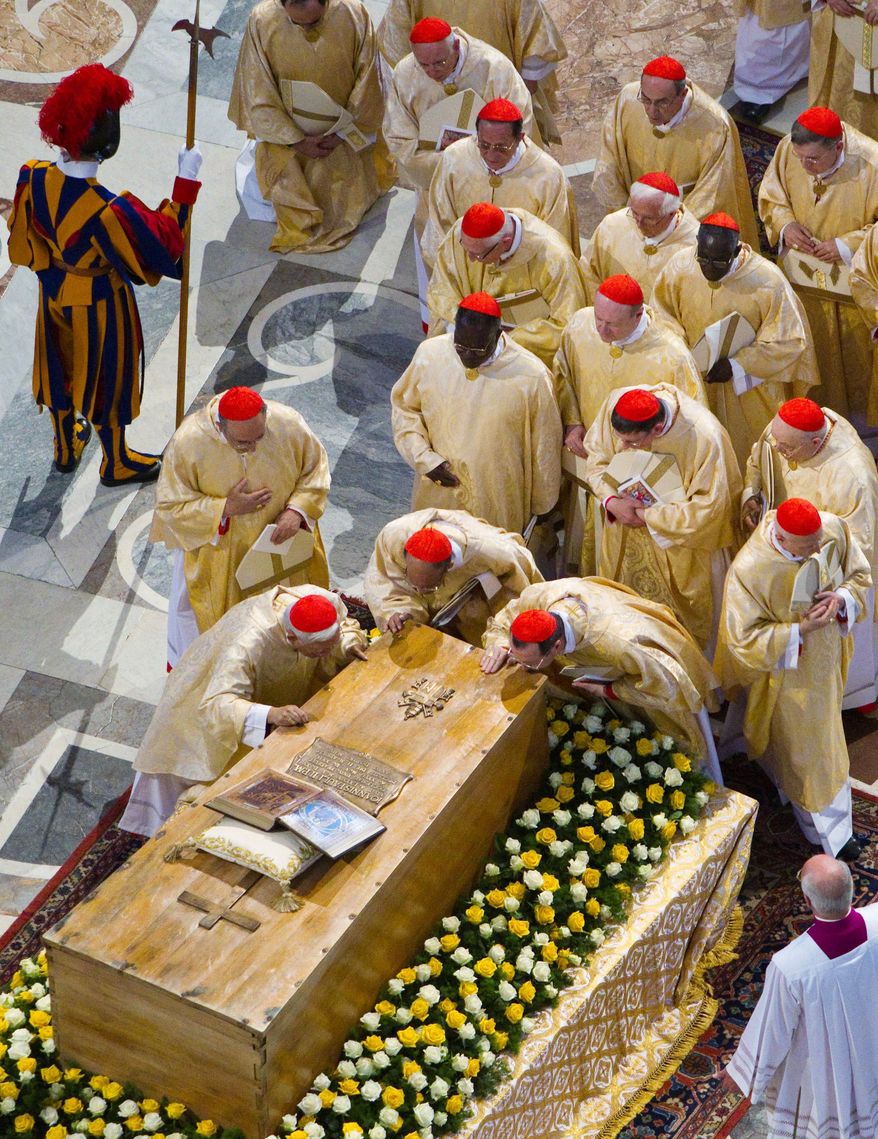 ASSOCIATED PRESS PHOTOGRAPHS
Cardinals kiss the casket of Pope John Paul II at the end of a solemn celebration Sunday in St. Peter's Square. The beatification of the late pontiff by Pope Benedict XVI is the fastest in modern times.