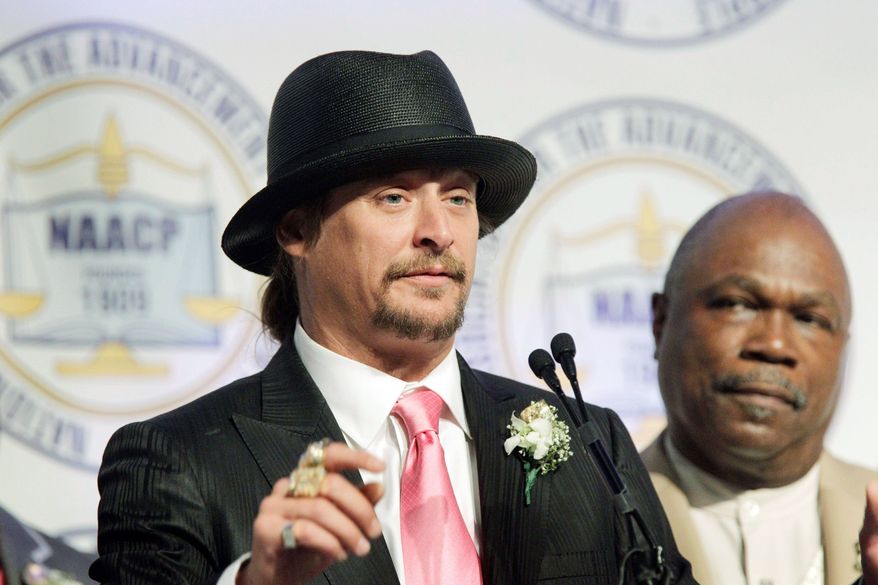 Associated Press
Kid Rock addresses the audience at the Detroit NAACP's annual fundraising dinner Sunday, as chapter President Wendell Anthony looks. The musician was honored for his support of the city.