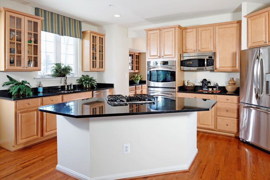 The Monroe model at Brinkley Manor features a center-island kitchen that opens to a breakfast area and includes a walk-in pantry. Buyers can add a butler's pantry between the kitchen and dining room.
