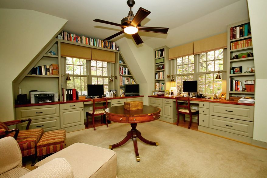 The upstairs home office has enough space for two people to work comfortably.