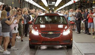 Associated Press
General Motors workers cheer as the first Chevrolet Cruze compact sedan rolls off the assembly line Sept. 8 at the GM factory in Lordstown, Ohio. Chevrolet said it sold 150,652 Cruze sedans during the first quarter of 2011.