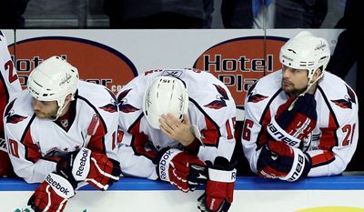 ASSOCIATED PRESS
Washington Capitals (from left) Matt Bradley, Boyd Gordon and Matt Hendricks wait out the final moments of their season in Wednesday night&#39;s 5-3 loss to Tampa Bay. The Lightning swept the Capitals in four games in their Eastern Conference semifinal series.