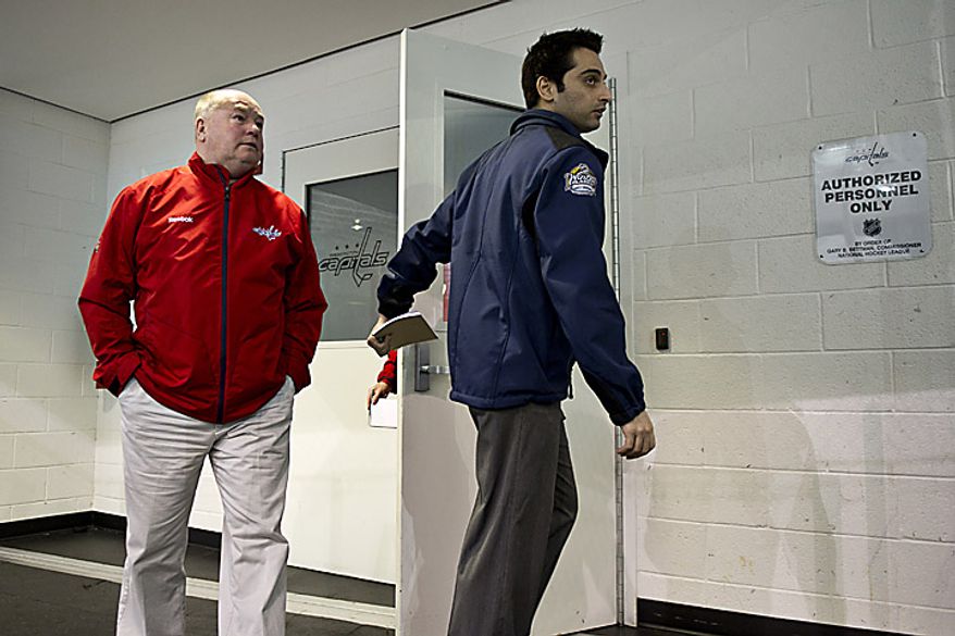 Capitals coach Bruce Boudreau emerges from the locker room on his way to talk to the media at the Kettler Ice Complex in Arlington on Thursday, May 5, 2011. (Drew Angerer/The Washington Times)