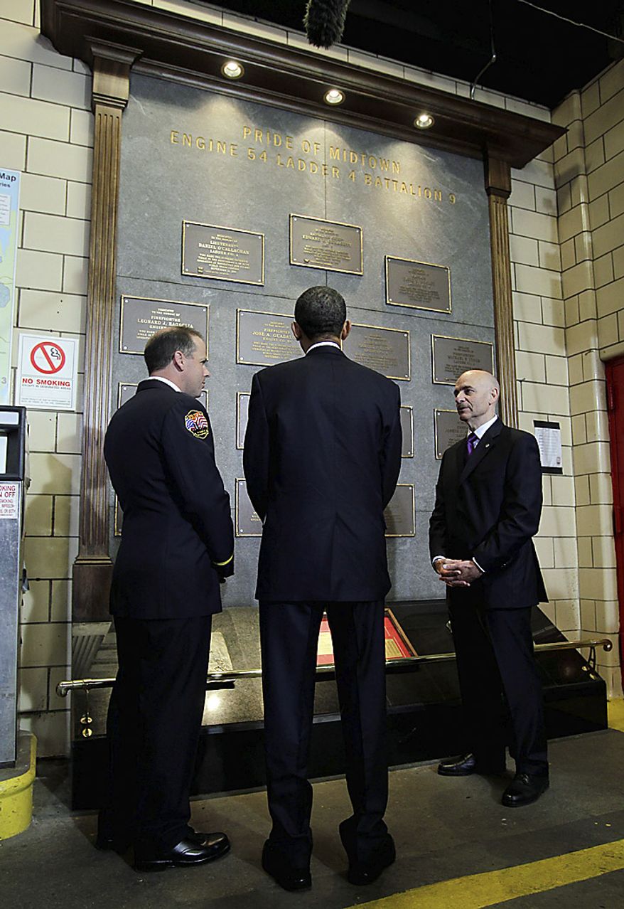 U.S. President Barack Obama, center, views a memorial honoring deceased members of the New York City Fire Department during a visit to the headquarters of Engine Company 54, Ladder Company 4 and Battalion 9, in New York, U.S., on Thursday, May 5, 2011. The firehouse lost 15 members, the single largest loss of life of any firehouse among the 343 firefighters who died during the attack on the World Trade Center on Sept. 11, 2001. Obama will go to New York's "Ground Zero" today, seeking to provide some closure to the worst terrorist attack on U.S. soil now that the world's most hunted terrorist, al-Qaeda leader Osama bin Laden, won't be "walking on this earth again." Photographer: John Angelillo/Pool via Bloomberg