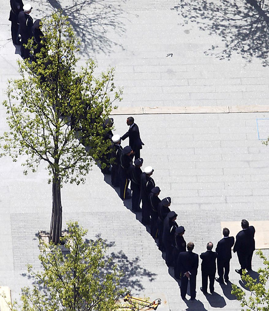 President Barack Obama, center, shakes hands with first responders as he arrives for a wreath laying ceremony at the September 11 Memorial at the World Trade Center site in New York, Thursday, May 5, 2011. (AP Photo/Mark Lennihan)
