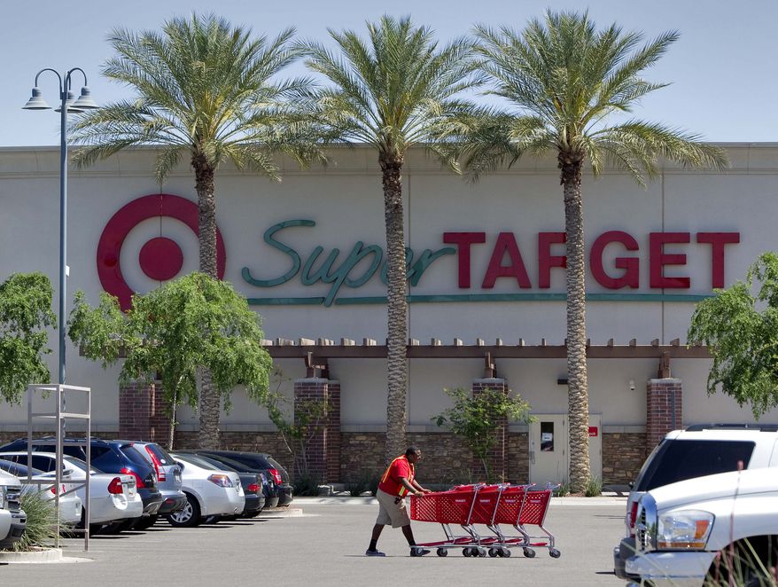 A Target employee retrieves shopping carts outside a company store in Gilbert, Ariz., on Tuesday, April 5, 2011. Retailers are reporting strong April sales that were helped by a late Easter, capping off a solid spring season. (AP Photo/Matt York)