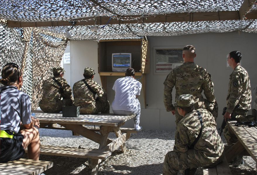 This image provided by the U.S. Army shows U.S. soldiers and service members as they watch the cable news coverage of the death of al Qaeda leader Osama bin Laden on a television at the Bagram air field on Monday. Bin Laden was slain in his hideout in Pakistan early Monday in a firefight with U.S. forces, ending a manhunt that spanned a decade. (Associated Press)