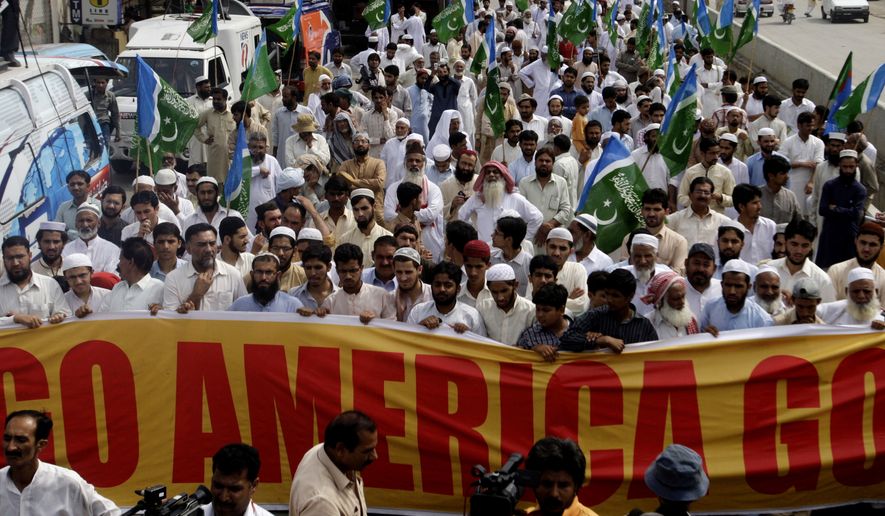 Supporters of the Pakistani religious party Jamaat-e-Islami rally Friday to condemn the killing of al Qaeda leader Osama bin Laden, in Lahore, Pakistan. Osama bin Laden was killed by a helicopter-borne U.S. military force on Monday, in a fortress-like compound on the outskirts of Pakistani city of Abbottabad. (Associated Press)
