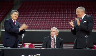 ** FILE ** University of Maryland president Wallace D. Loh (left) and director of athletics Kevin Anderson (right) applauded an emotional Gary Williams during the news conference when Williams officially announced his retirement as the school&#39;s basketball coach after nearly 22 years. (Barbara L. Salisbury/The Washington Times)