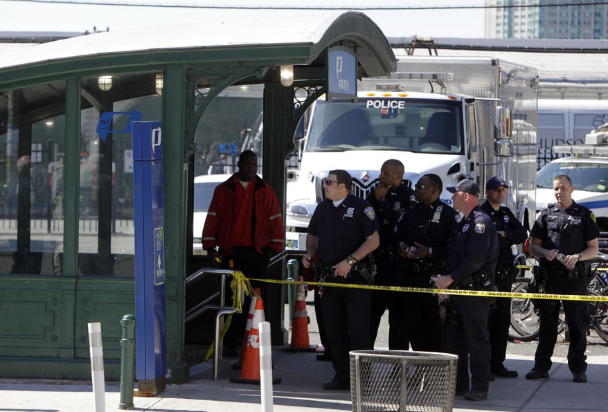 Emergency personnel gather near the entrance to the Port Authority Trans-Hudson (PATH) train station in Hoboken, N.J., on Sunday, May 8, 2011, after a train pulling into the station struck an abutment, causing minor injuries. (AP Photo/Seth Wenig)