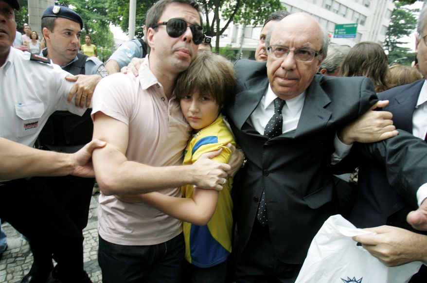 ASSOCIATED PRESS
"They dragged him through the streets, for God's sake. That shows what they care about - and it wasn't him," said David Goldman of the day his son, Sean, was brought to the U.S. Consulate in Rio de Janeiro to be reunited with his father. He was accompanied by his Brazilian stepfather, Joao Paulo Lins e Silva (left), and attorney Sergio Tostes.