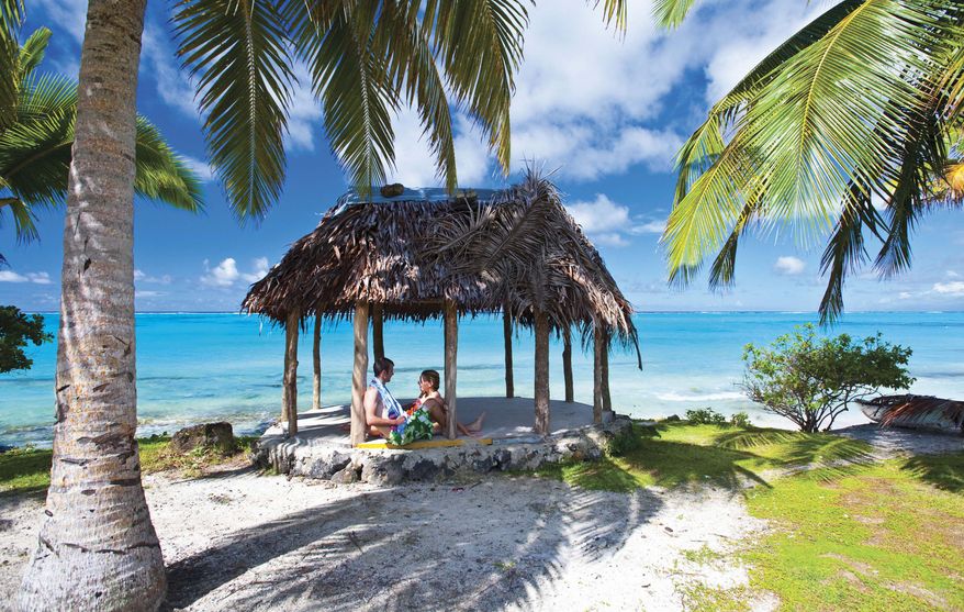 A couple relax on a beach in the South Pacific island nation of Samoa, which, for economic reasons, has announced plans to jump forward in time by one day by switching to the west side of the international date line. (AP Photo/Samoa Tourist Authority, D. Kirkland)