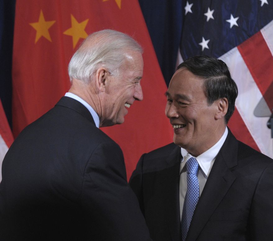 Vice President Joseph R. Biden Jr. greets Chinese Vice Premier Wang Qishan during the opening session of the U.S.-China Strategic and Economic Dialogue (S&amp;ED) on Monday, May 9, 2011, at the Interior Department in Washington. (AP Photo/Susan Walsh)

