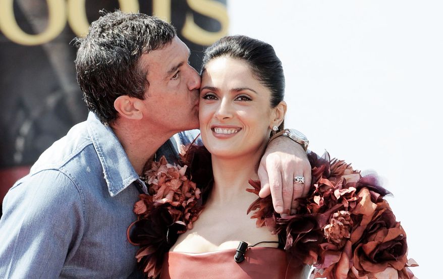 Antonio Banderas kisses Salma Hayek while promoting "Puss in Boots." "If Salma was beautiful in two dimensions, imagine her in three dimensions," Mr. Banderas said while wearing 3-D glasses.